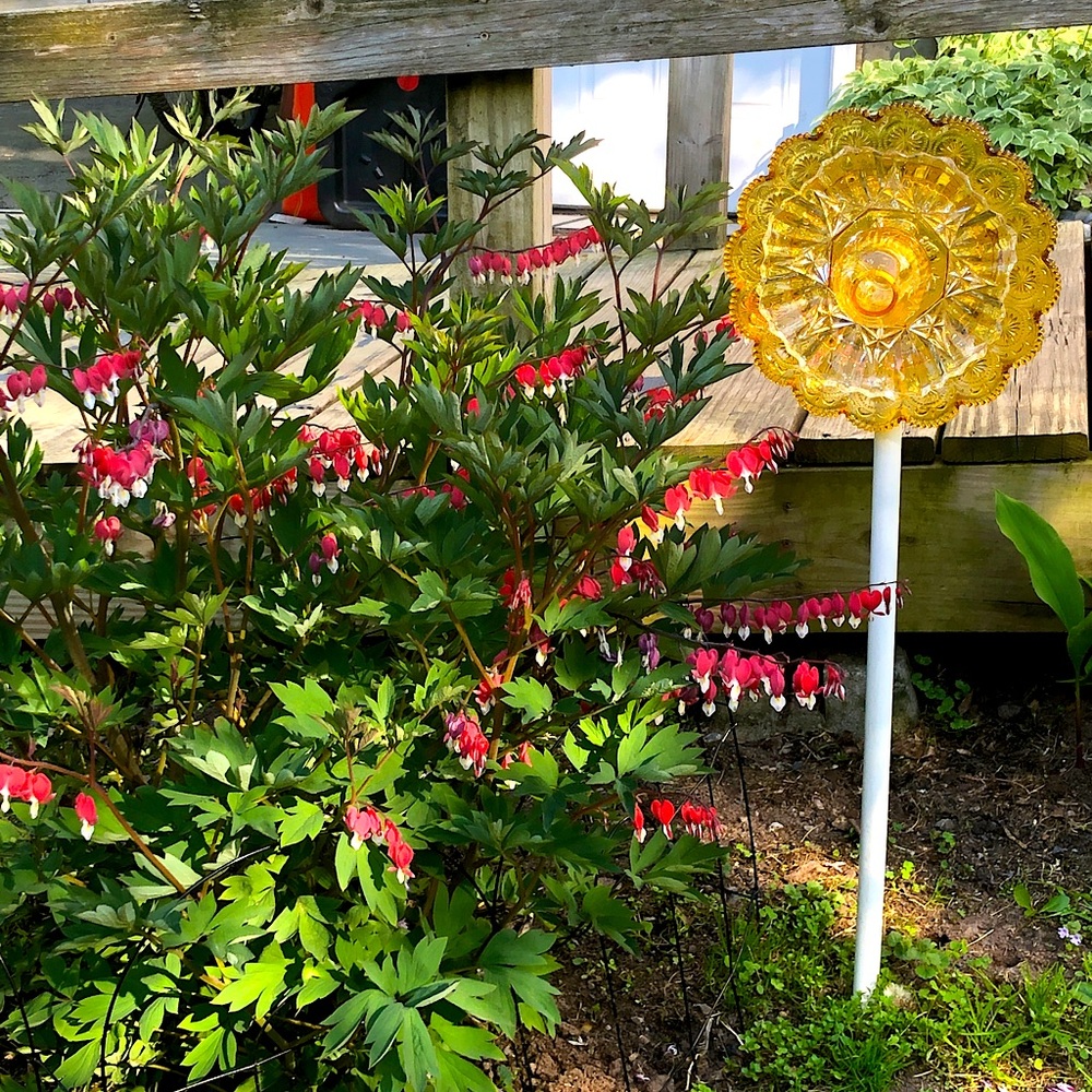 Upcycled vintage glass dishes into garden accessories: flowers, birdfeeders, etc